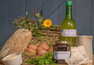 Taste of Cotna Eco Retreat vegetarian breakfast hamper for glamping guests with home-made sourdough bread, organic eggs, home-made jam, freshly pressed Cornish apple juice from the Roseland