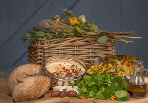 Taste of Cotna Eco Retreat late arrival hamper, vegetarian or vegan for yurt holiday guests glamping on the Roseland in Cornwall. Includes home-made hummus, organic salads, sourdough bread, and home-brewed cider, beer or elderflower cordial